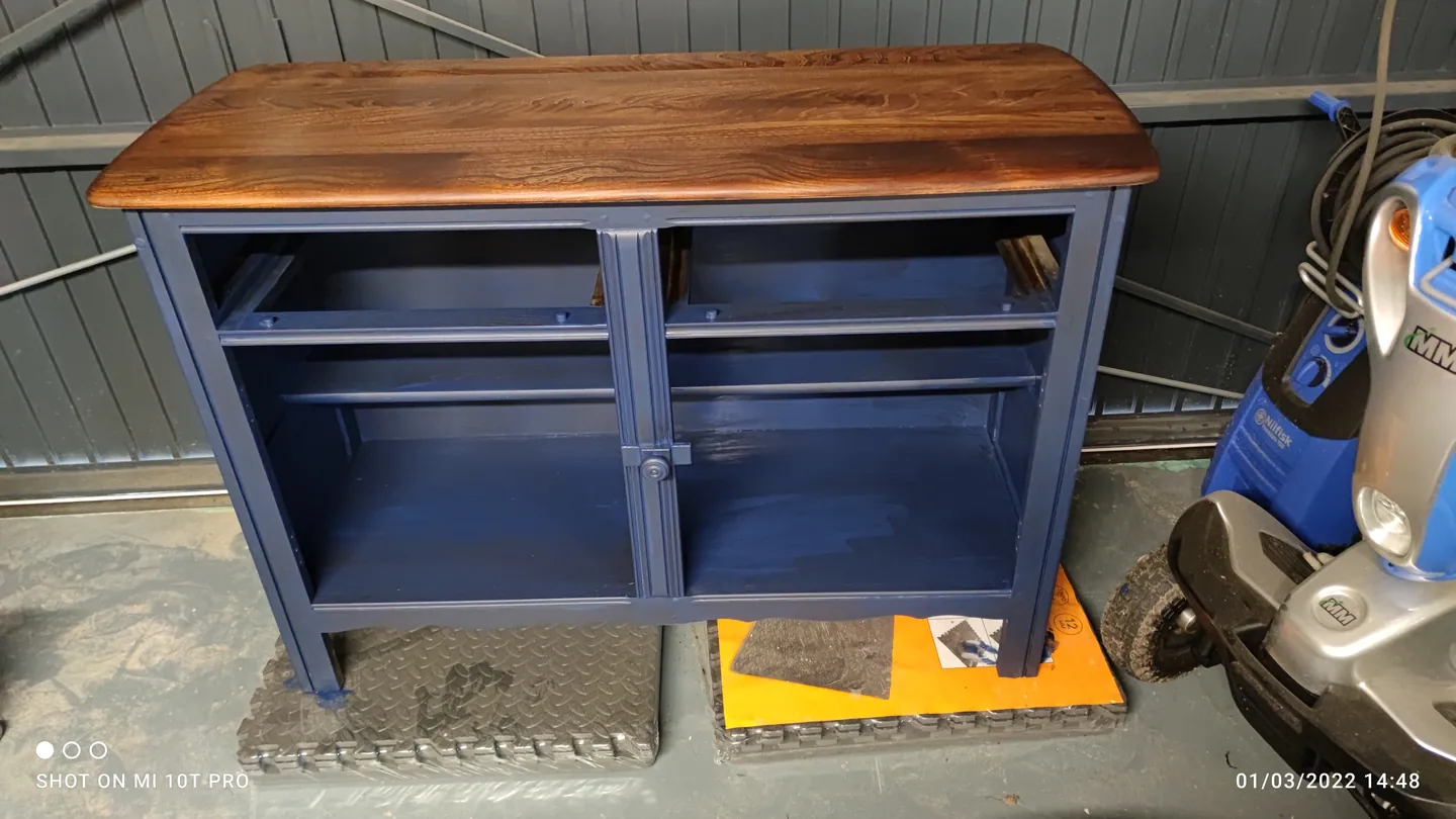 The same navy cabinet after the timber top has been finished