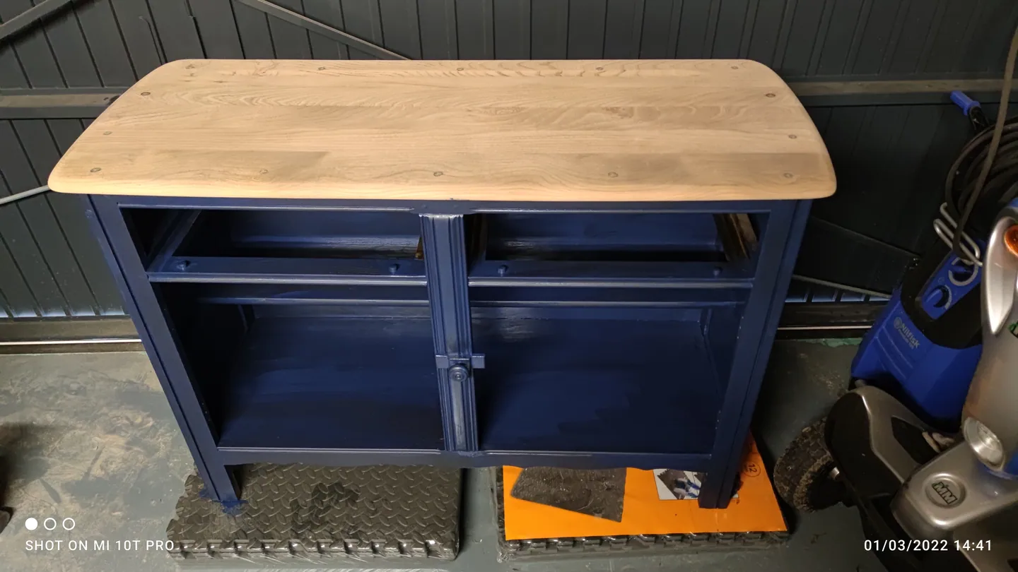 Navy cabinet with a pale bare timber top before finishing