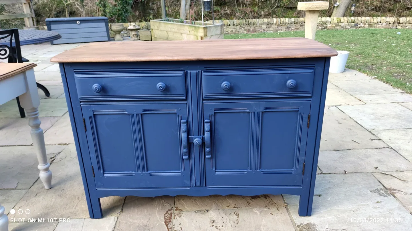 Finished navy painted cabinet with drawers, doors and a warm timber top