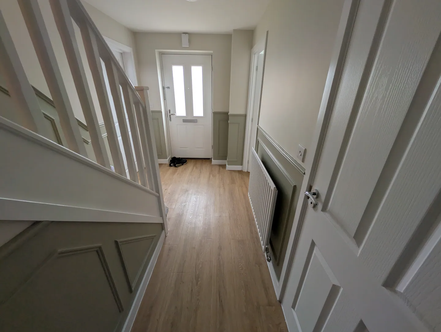 Painted wall mouldings and bannisters viewed down the staircase