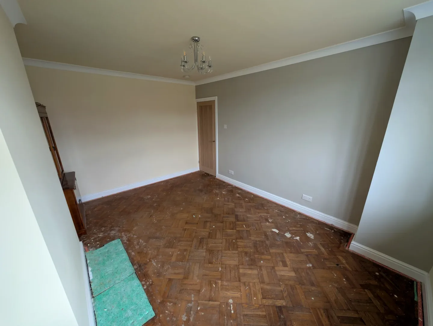 Neutral painted room with wooden floor and white ceiling