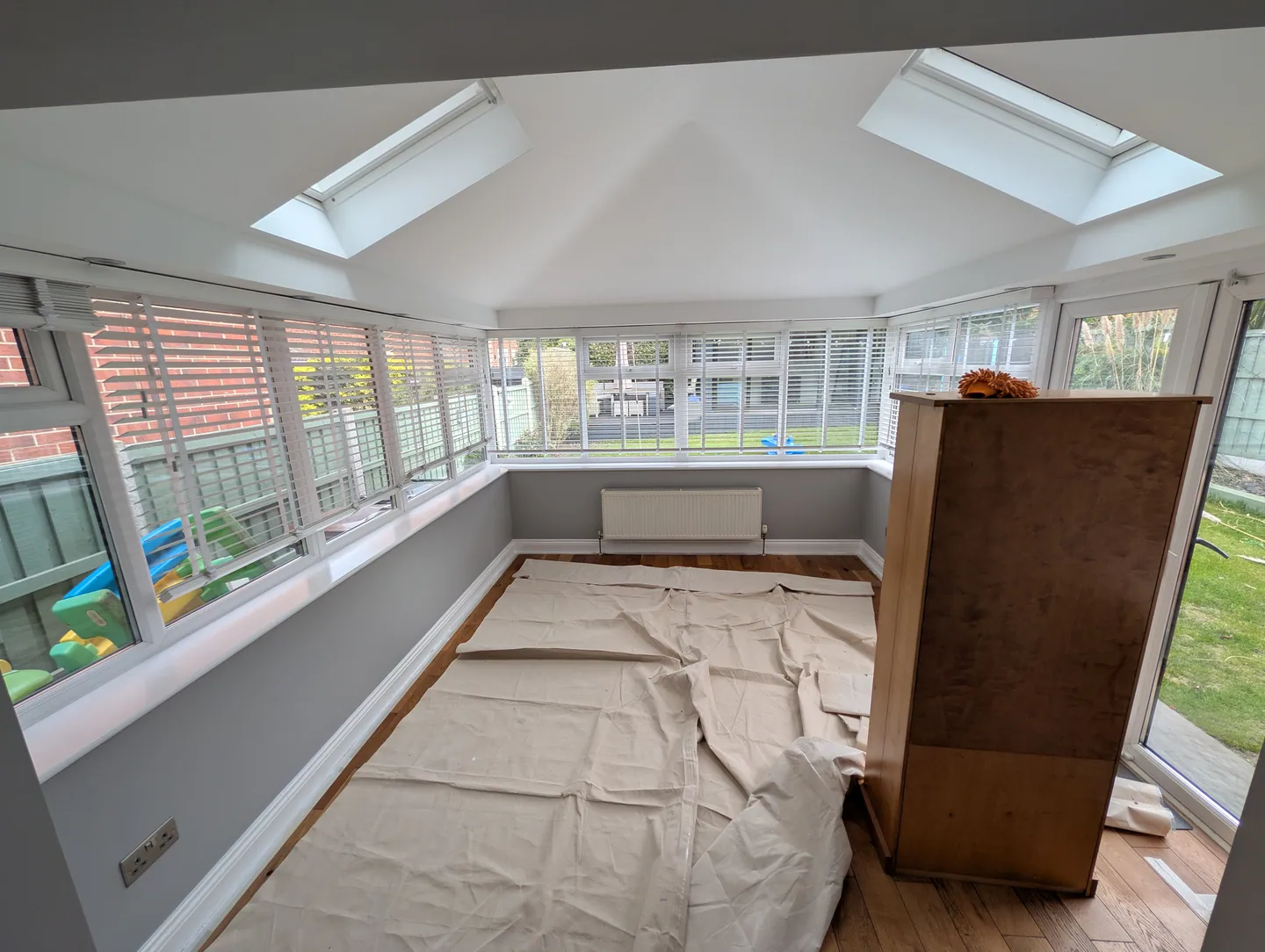 Sunroom during decorating with furniture and flooring protected